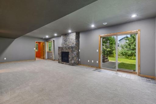 Gas fireplace and sliding door to patio, deck and yard