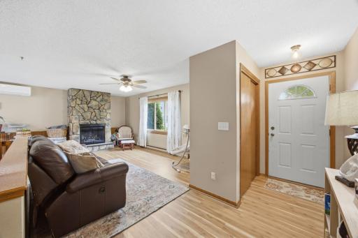 Foyer to Living Room w/New Laminate Flooring and Fireplace with Stone Surround