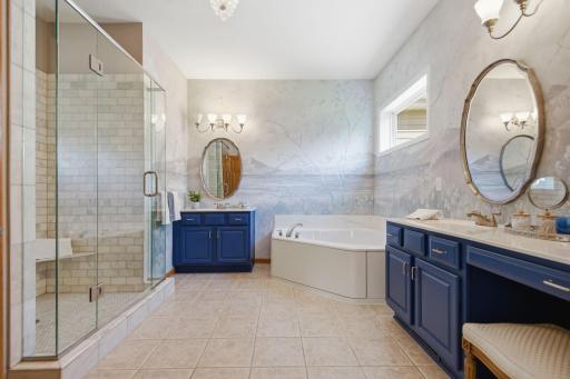 Primary bathroom professionally painted by a local artist - the walls were painted to reflect a nature scene - A serene retreat for soaking in tub, complemented by 2 separate vanity areas offering generous counter & cabinetry space (new shower area.)