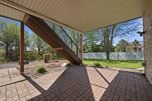 A charming lower-level patio offers a peaceful retreatâperfect for staying cool on warm days or relaxing while watching the rain on a cool summer afternoon.