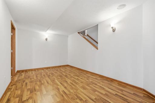 To the right as you descend the steps, youâll find a versatile bonus space with endless possibilitiesâideal as a workout area, playroom, sitting area, craft room, or whatever best suits your lifestyle.