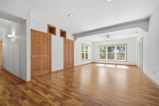 The LL living/family room is thoughtfully designed with upper display cubbies for treasured items and concealed storage behind the two lower doors. walks out to a private patio and is enhanced by oversized daylight windows.
