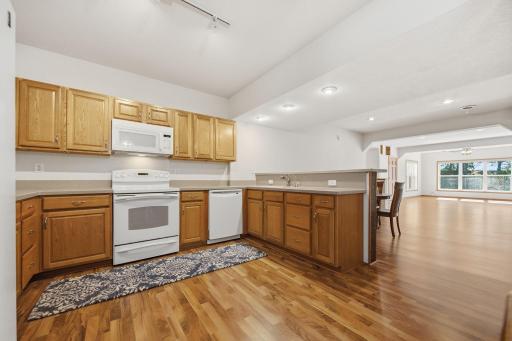 A view of the full kitchen equipped with a range/oven, microwave, dishwasher and Refrigerator not to mention lots of counter and cupboard space.