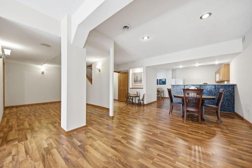 Designed with entertaining in mind, the Lower Level offers an impressive array of amenities, including a full kitchen, dining room, laundry room, guest bedrooms, a spacious living and billiards area, fitness space, and private theatre room/