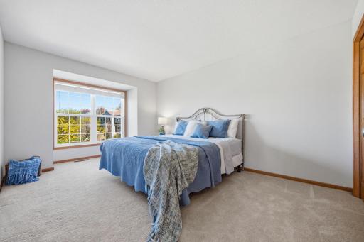 This additional upstairs bedroom is generously sized, featuring ample closet space and abundant natural light. The carpet is also in excellent condition.