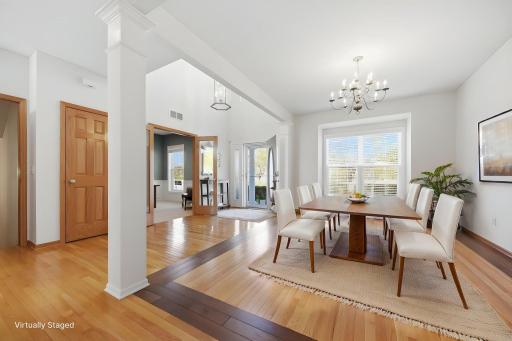 The front room is virtually staged to highlight its versatility and potential as a refined formal dining room.
