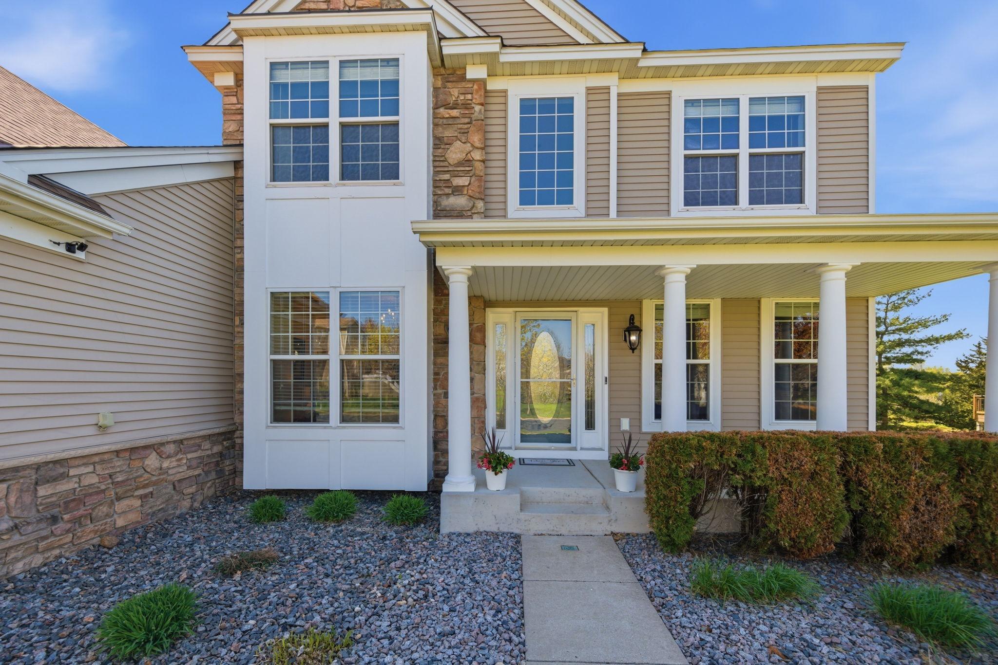 This beautiful custom Pulte-built home welcomes you with an impressive two-story foyer, creating a grand and elegant entrance with stone and maintenance free siding.