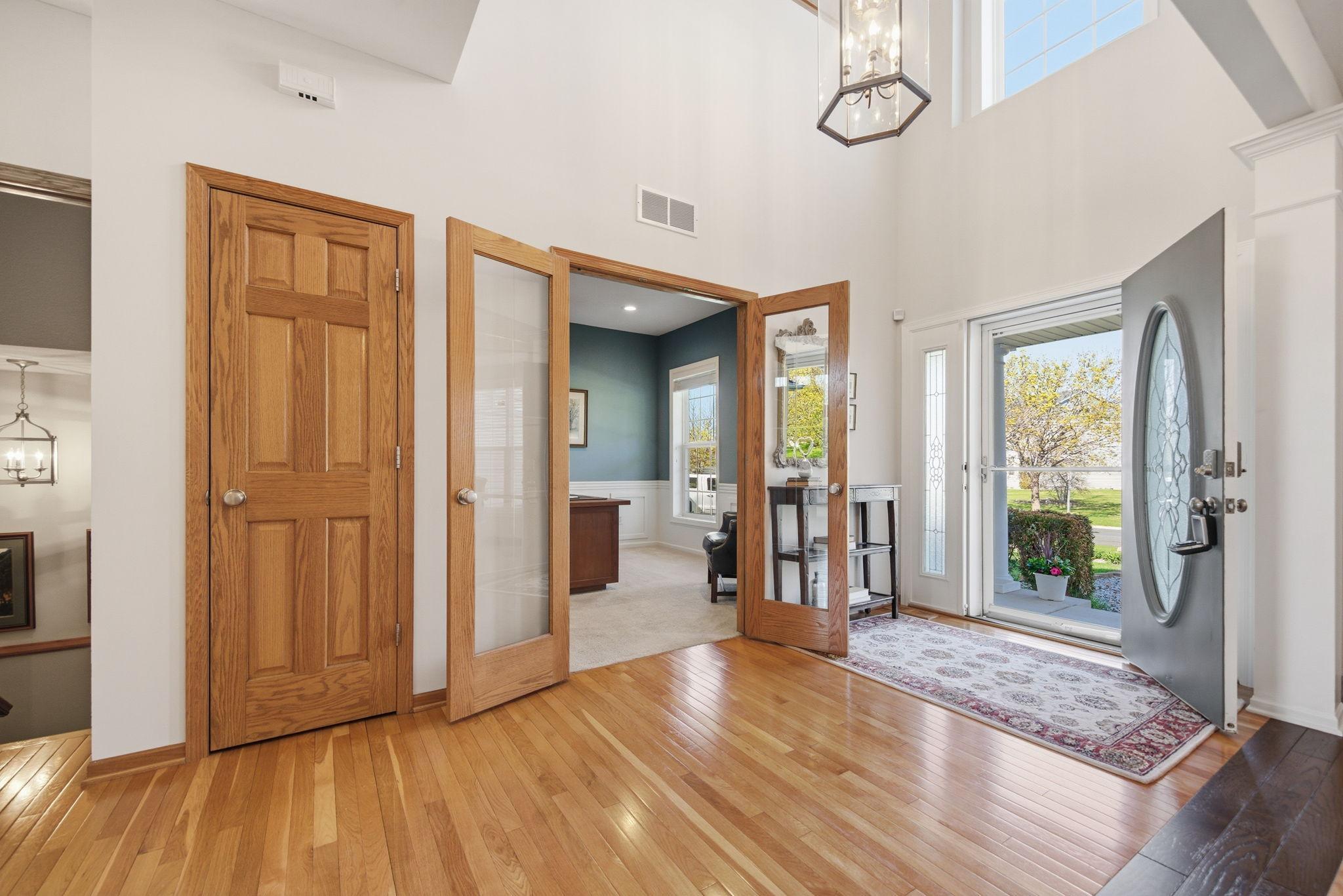 A grand two-story foyer with beautiful wood floors sets the tone for this meticulously maintained home.