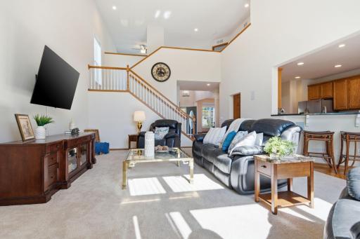 This photo beautifully highlights the spacious living room layout, open flow, and bright, airy feel.