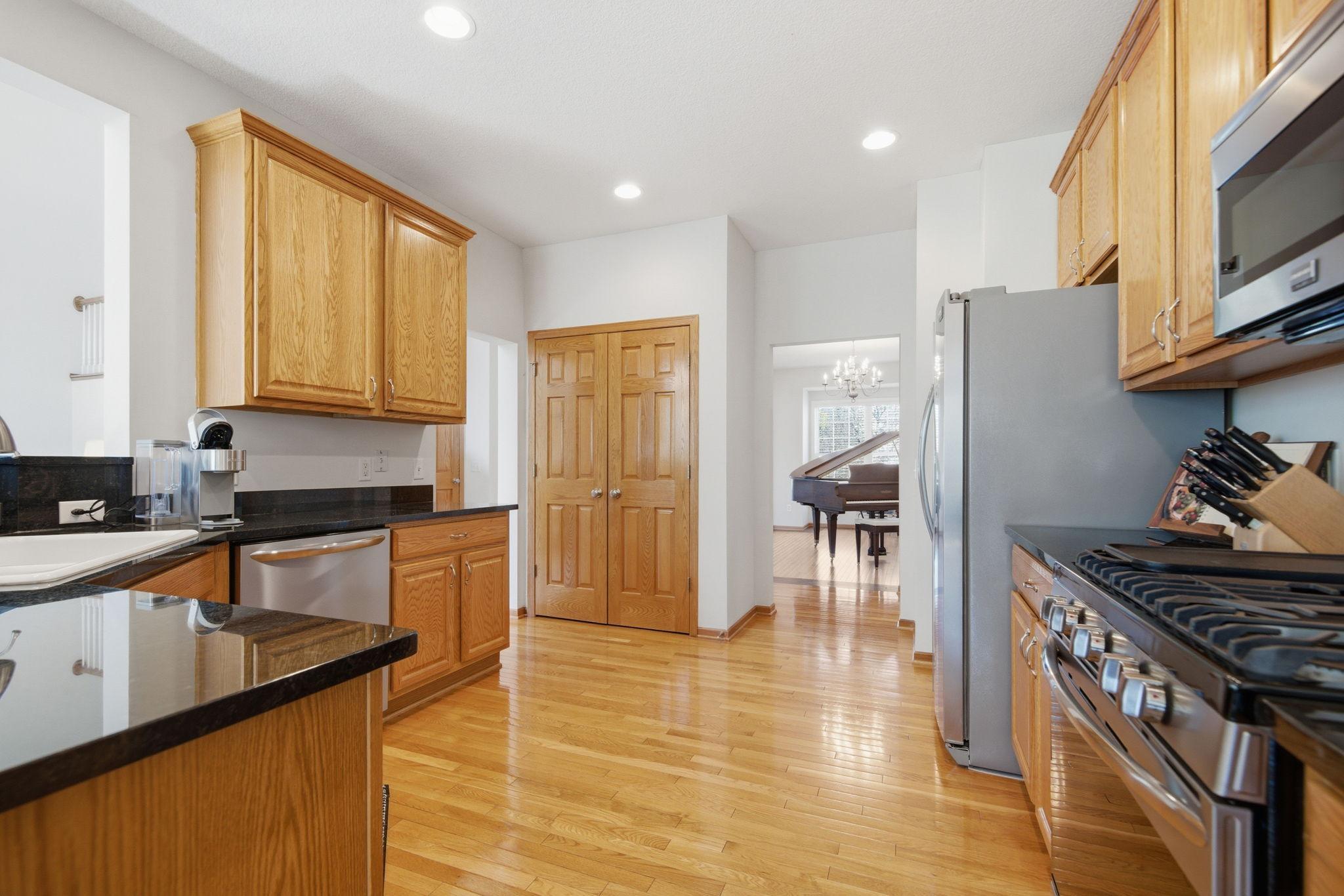 The open kitchen is thoughtfully designed for entertaining, offering generous counter space, extensive cupboard storage, and an impressive amount of storage. The kitchen has newer Stainless Steel appliances, - Stove, Dishwasher and Refrigerator