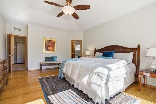This photo shows the main-floor primary bedroom with an attached primary bath, offering the convenience of aging in place while still leaving plenty of room for grandkids down the road.