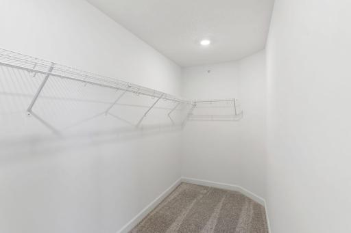 This oversized walk-in closet with built-in shelving optimizes wardrobe organization