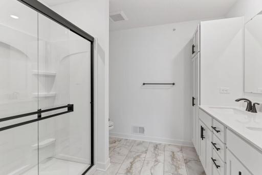 Quartz countertops, MoenÂ® Glyde faucets and dual sinks come together at this impressive vanity