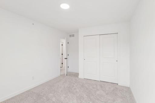 All bedrooms in the home include plush wall-to-wall carpeting and practical wardrobe closets