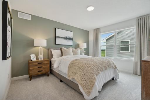 (Photo of a decorated model, actual homes finishes will vary) One of three secondary bedrooms. This one includes a private bath.