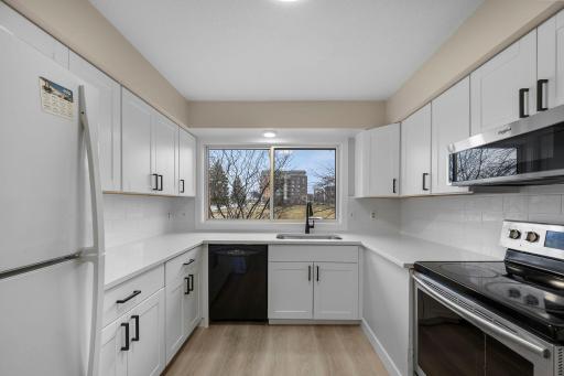 Bright and modern kitchen featuring sleek white cabinetry, stainless steel appliances, and clean finishesâperfect for everyday cooking and entertaining.
