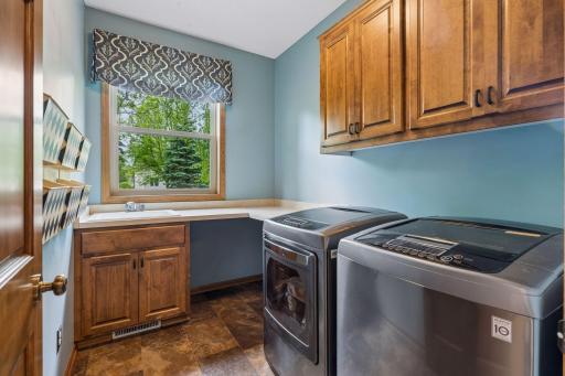 Main level laundry with sink and plenty of storage