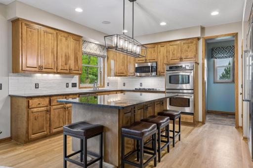 Chef's kitchen with custom cabinetry, granite counter tops and large center island