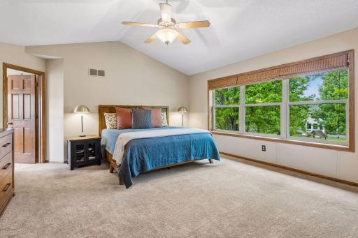 Primary bedroom with private full bathroom and walk-in closet with custom built-ins
