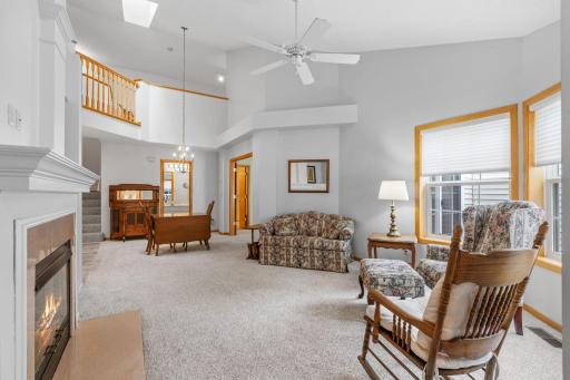Another view shows the vaulted ceilings rising to impressive 2 stories, also skylight offers additional light bright spaces. Cozy up to warm fireplace on winters first snowfall-perfect place to read your favorite book