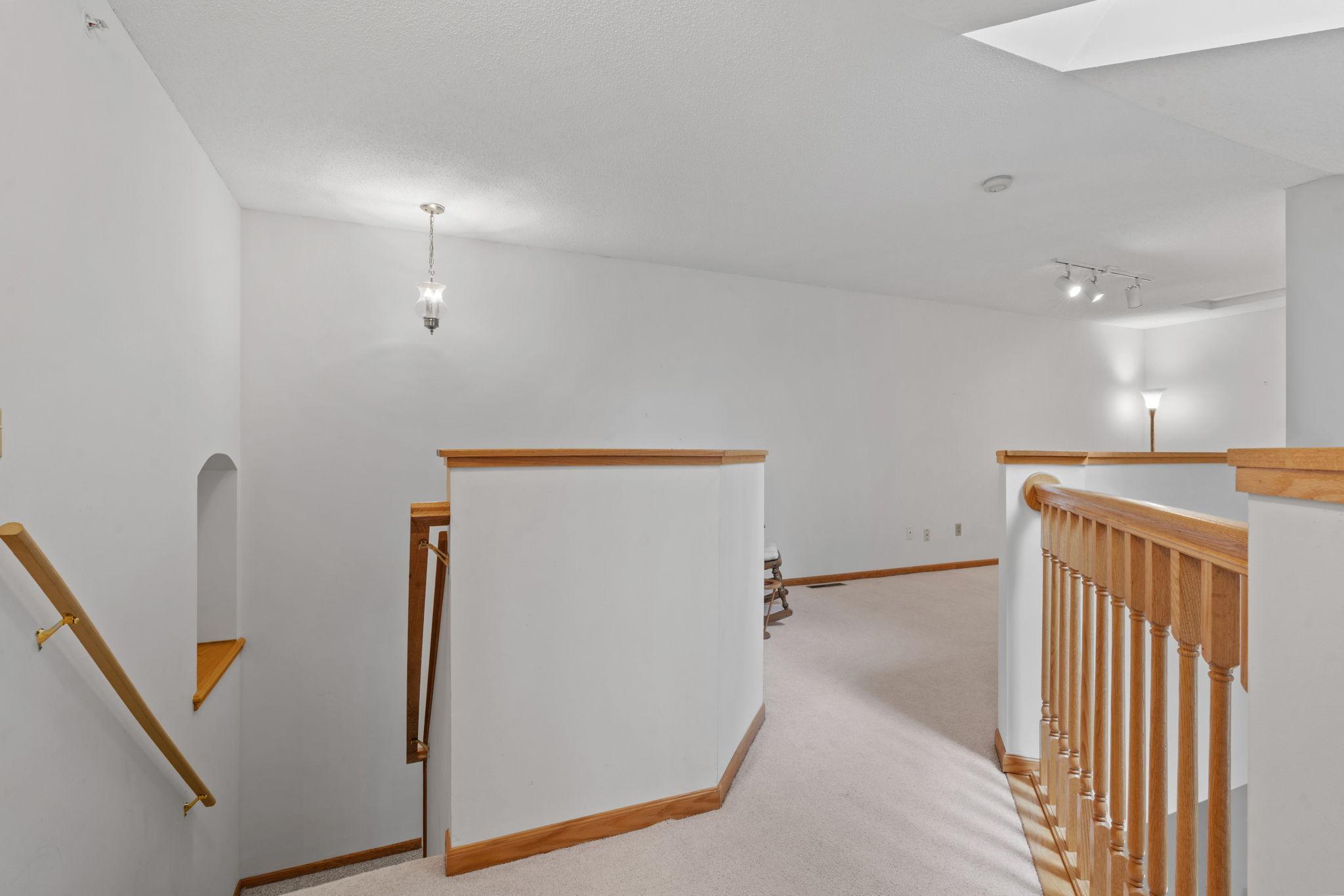 Staircase with open railing above