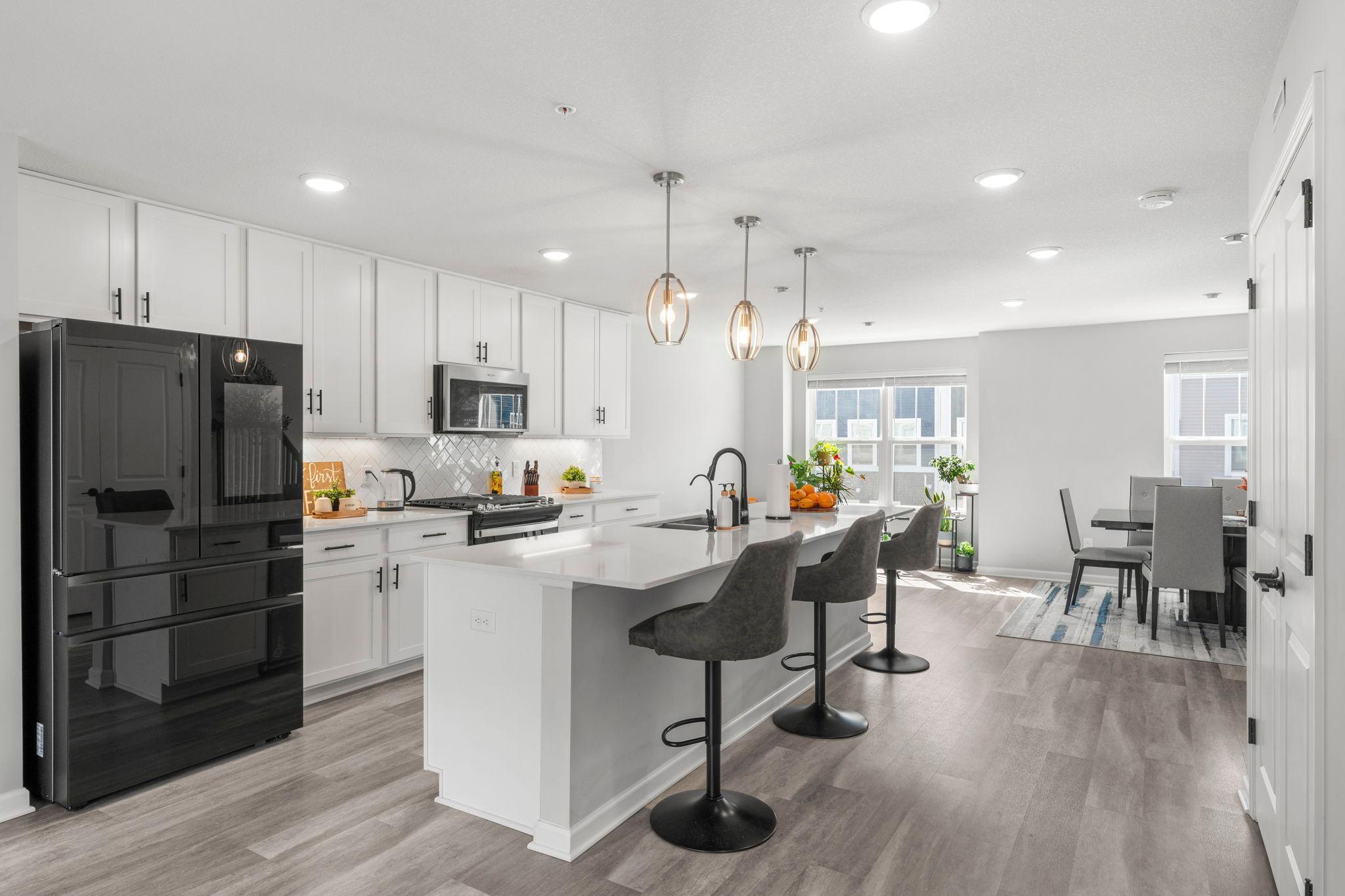 Chef ready kitchen featuring premium Quartz countertops, a gas range, and upgraded stainless steel appliances.