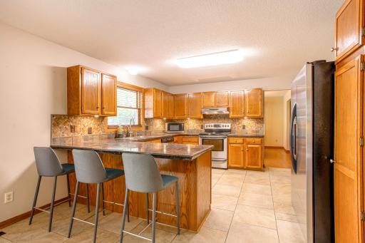 Designed for everyday living and entertaining, the open kitchen offers generous prep space and seamless flow into the adjacent dining room.