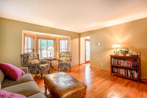 The spacious living room offers flexible seating and abundant natural light, perfect for relaxing or entertaining.