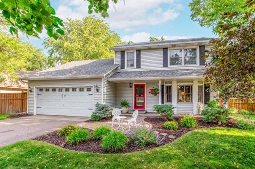 Welcome home to this beautifully maintained two-story nestled on a mature, tree-lined lot with timeless curb appeal.