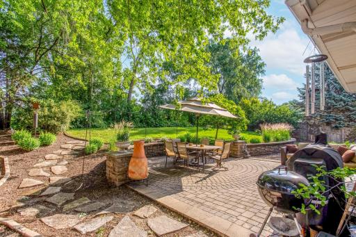The spacious paver patio provides the perfect outdoor retreat for entertaining, dining, or simply enjoying the private backyard.