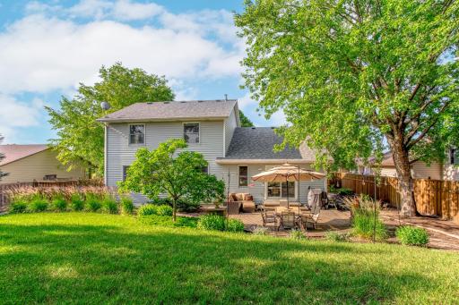 The expansive backyard offers exceptional privacy, mature trees, and beautifully landscaped outdoor living spaces.