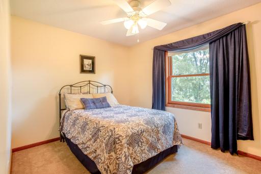 The comfortable third bedroom offers abundant natural light, generous closet space, and flexibility for family or guests.