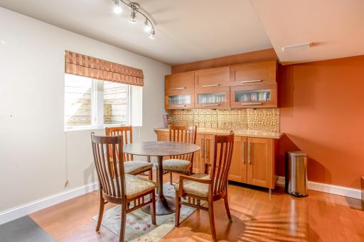 A centrally located bar area with built-in cabinetry provides the perfect space for snacks, drinks, or casual dining.