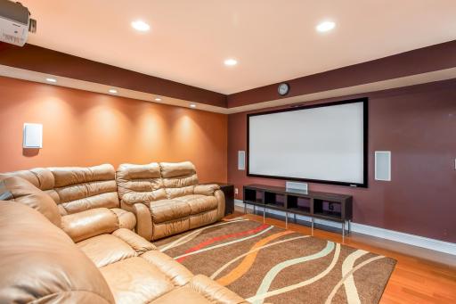 Enjoy an immersive entertainment experience in this inviting theatre room, thoughtfully designed with recessed lighting and comfortable seating.