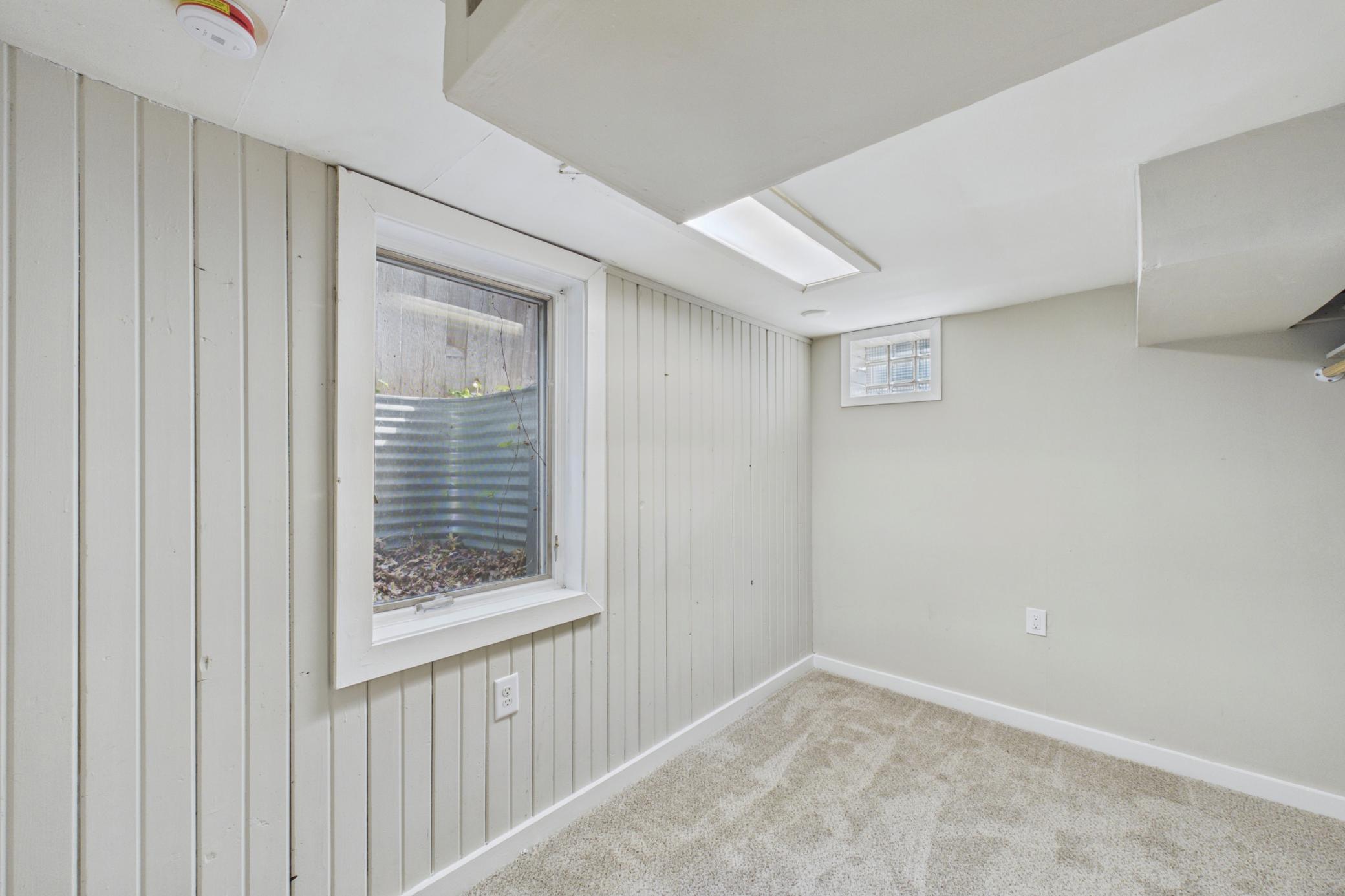 Lower level bedroom with egress window and updated flooring and paint