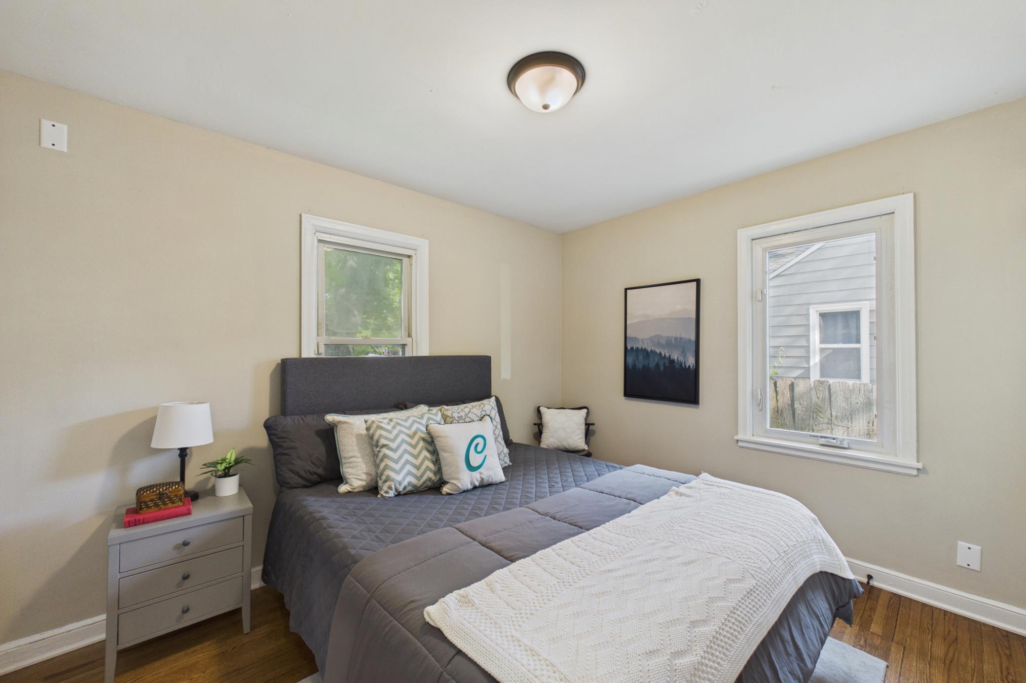 Main level bedroom with hardwood floors and neutral finishes.