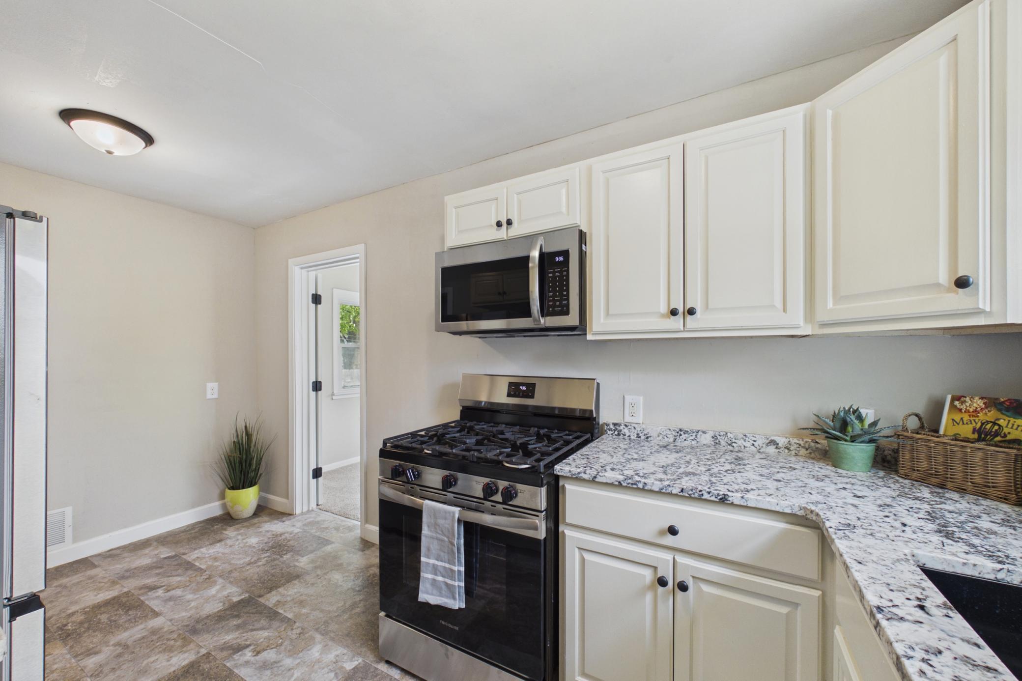 Kitchen featuring gas range, microwave, and ample cabinet storage.