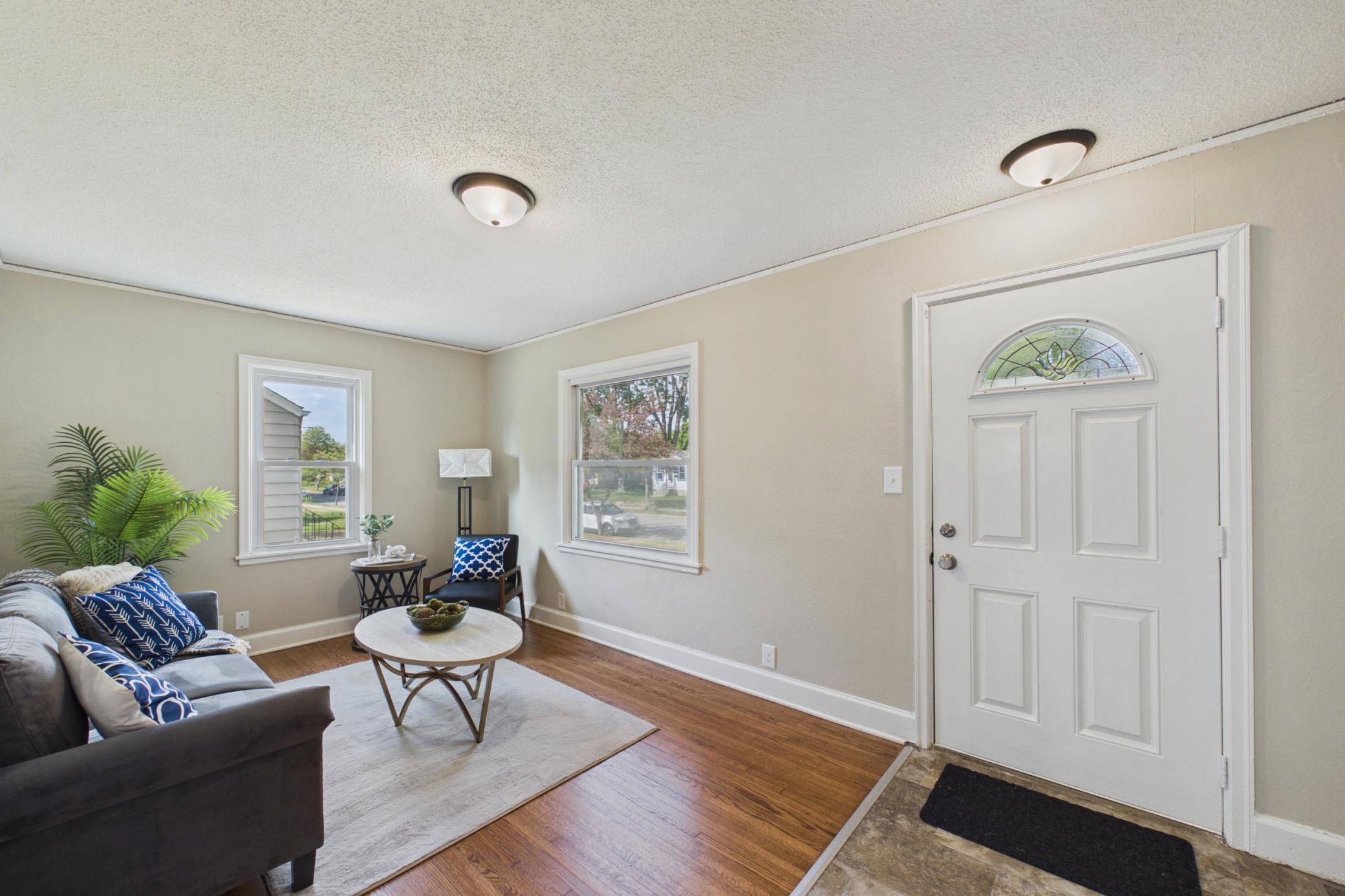 Front living room with hardwood floors and natural light.