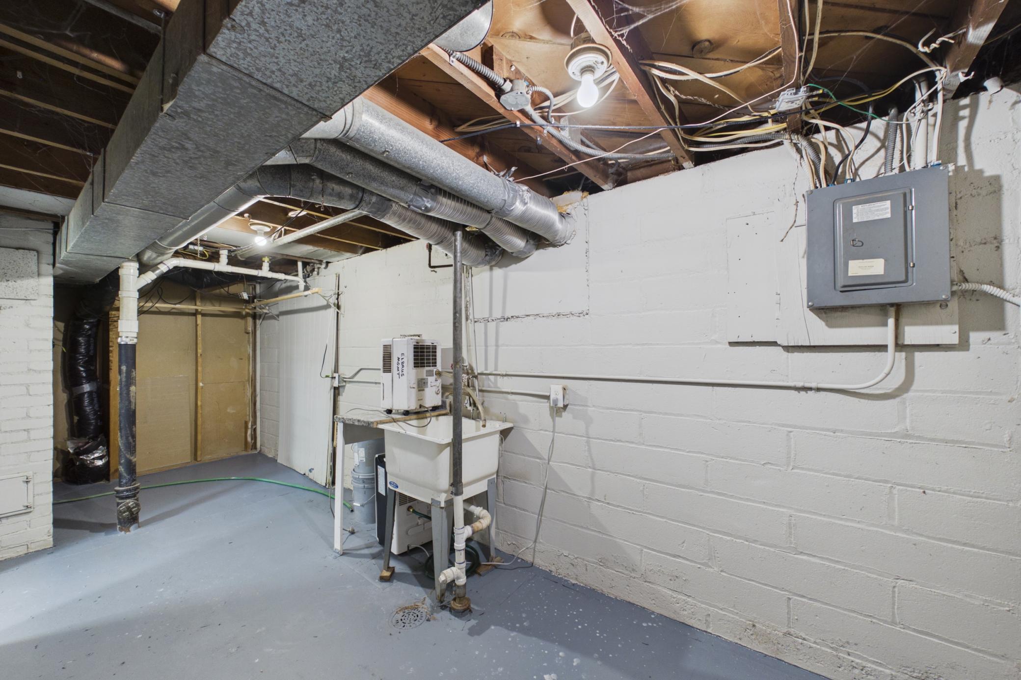 Utility/laundry area with additional storage space.