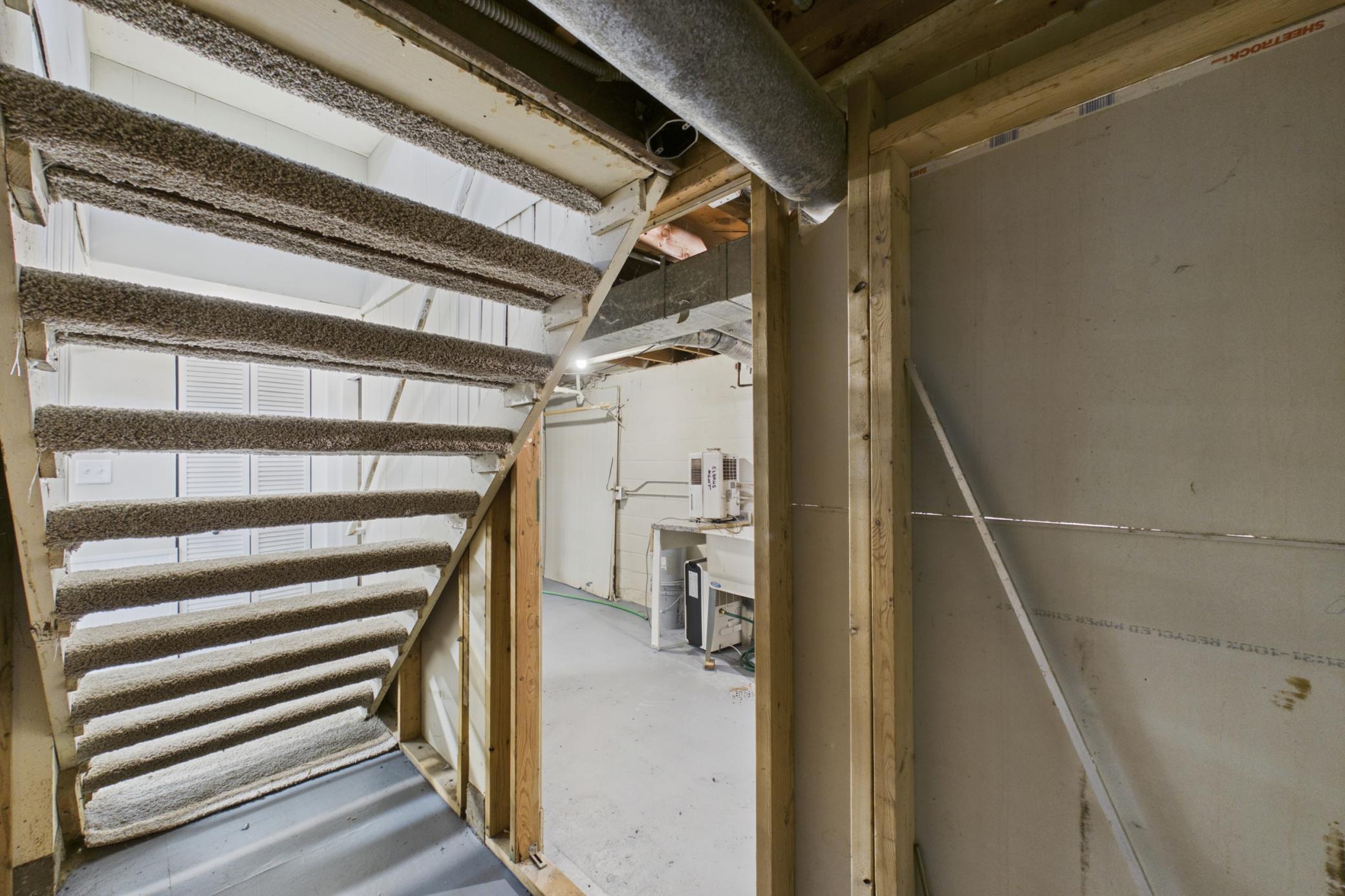 Basement stairway and utility area access.