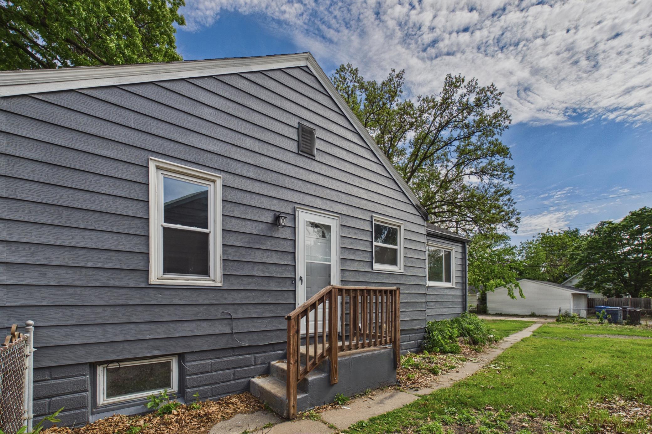 Side exterior entry with updated exterior paint and backyard access.