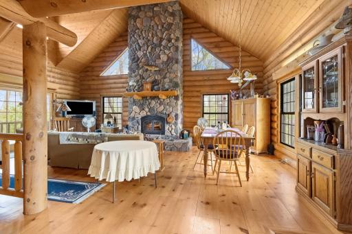 Vaulted living room with floor to ceiling stone fireplace