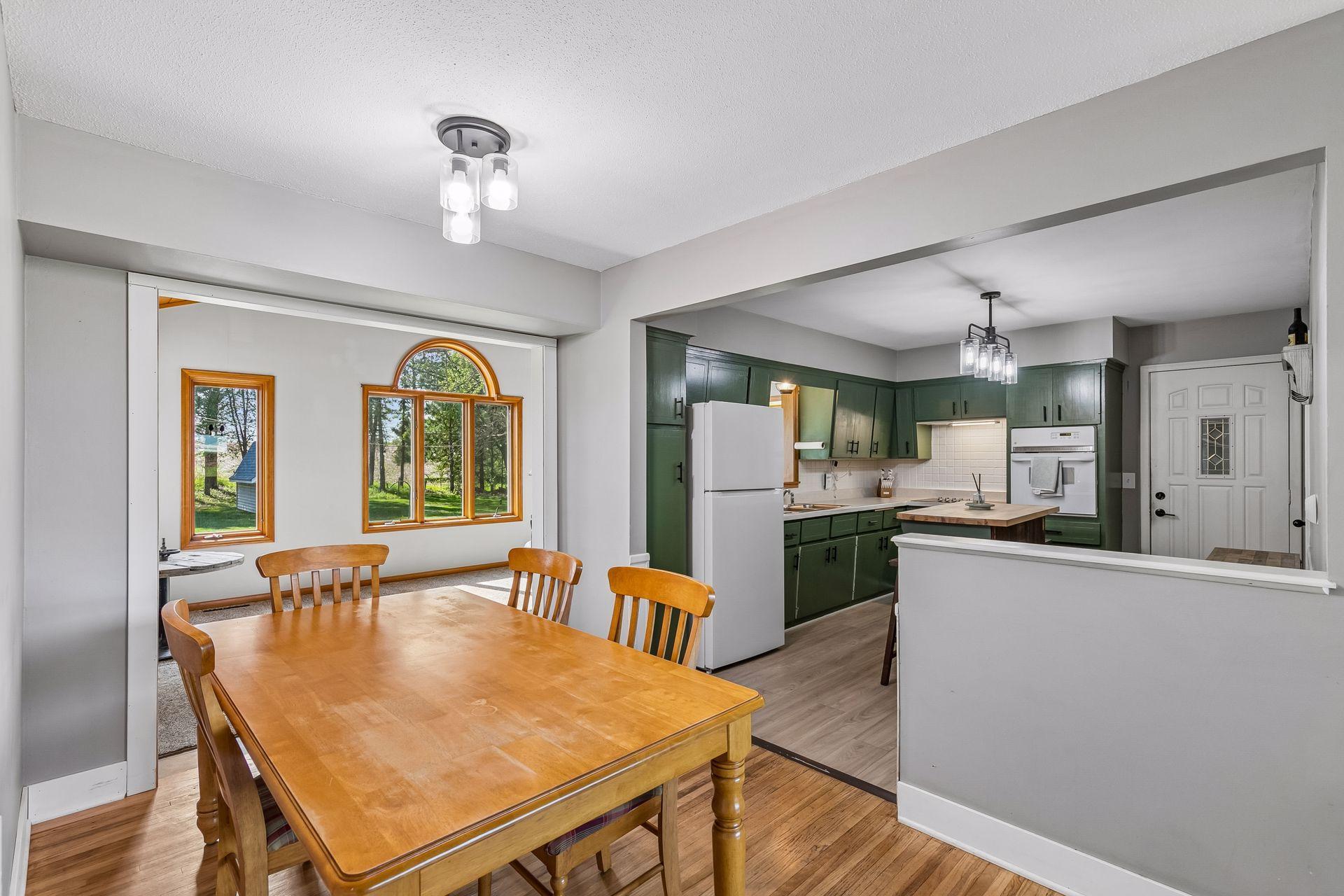 Functional dining area flows nicely between the living room, kitchen, and family room/sun room.