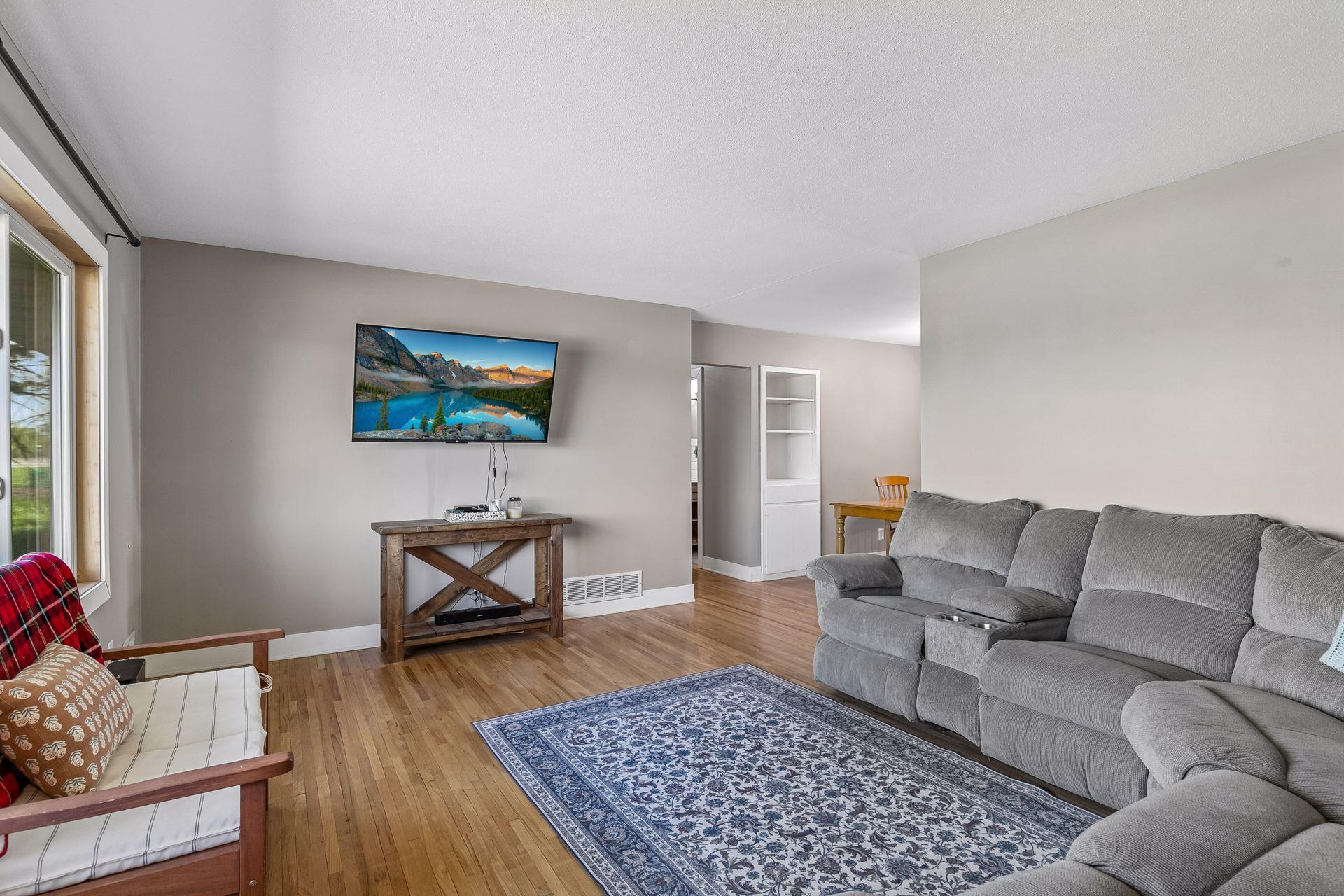 Living room features well-maintained original hardwood floors.
