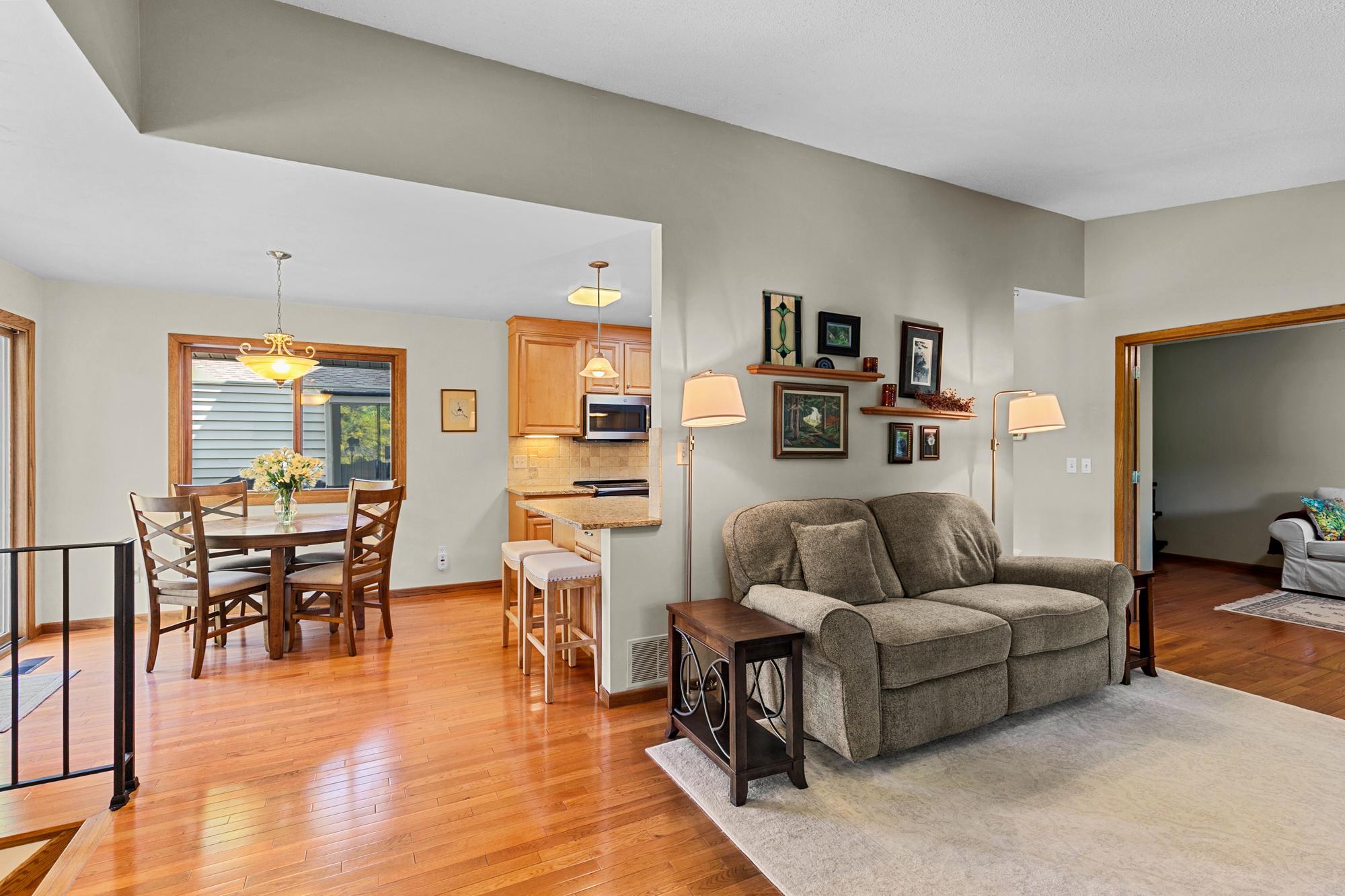 Note the main level open floor plan, the gleaming hardwood floors, outdoor spaces and views. Steps to the second, main level, bedroom / den / flex room.