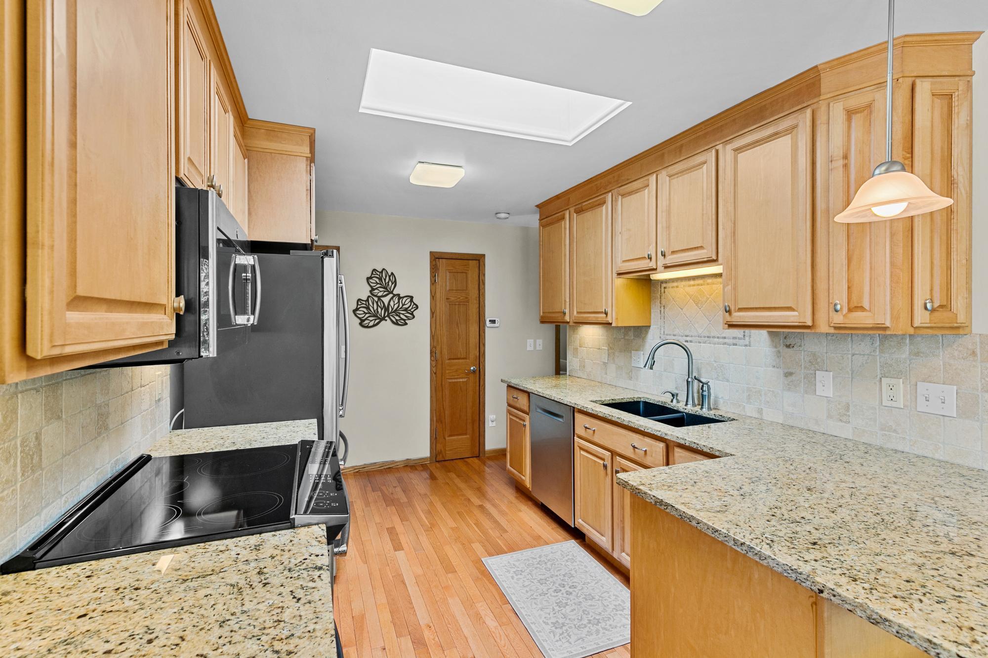 Granite, Custom Backsplash, Custom Maple Cabinetry with , GE Profile - Stainless Steel appliances, induction range, Gleaming hardwoods. Timeless.