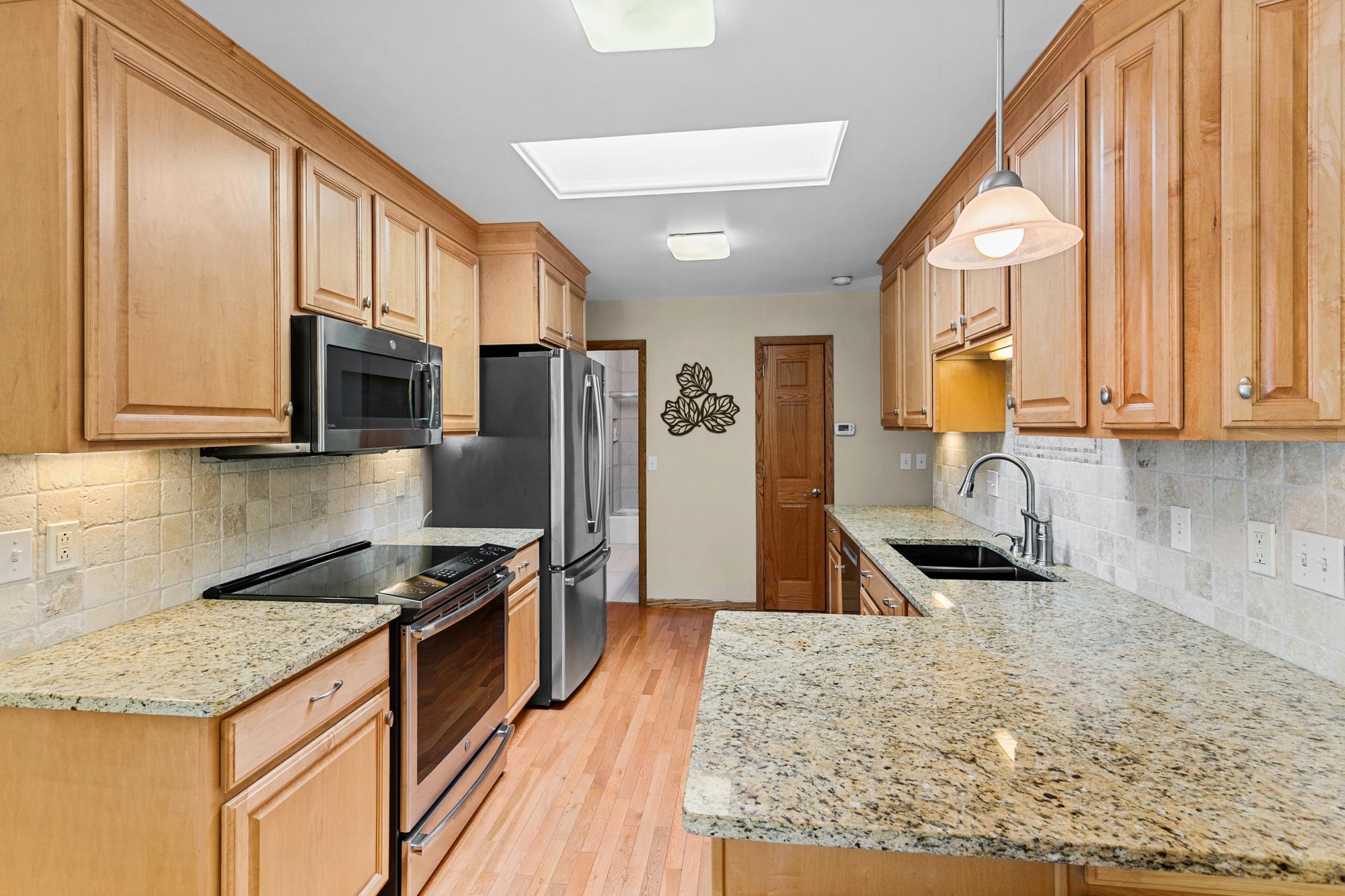 The craftsmanship and quality of the kitchen space is evident in every feature. The room is highlighted and enhanced by the large, sun-filled skylight.