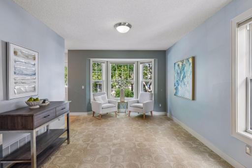 Elegant front living room with bay window and French doors. Versatile main floor office, music room or den.