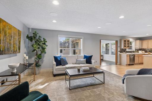 Open concept floor plan between the kitchen/dining space, family room and adjacent sun room.