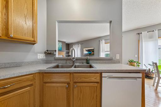 You can see the living room and backyard from the sink